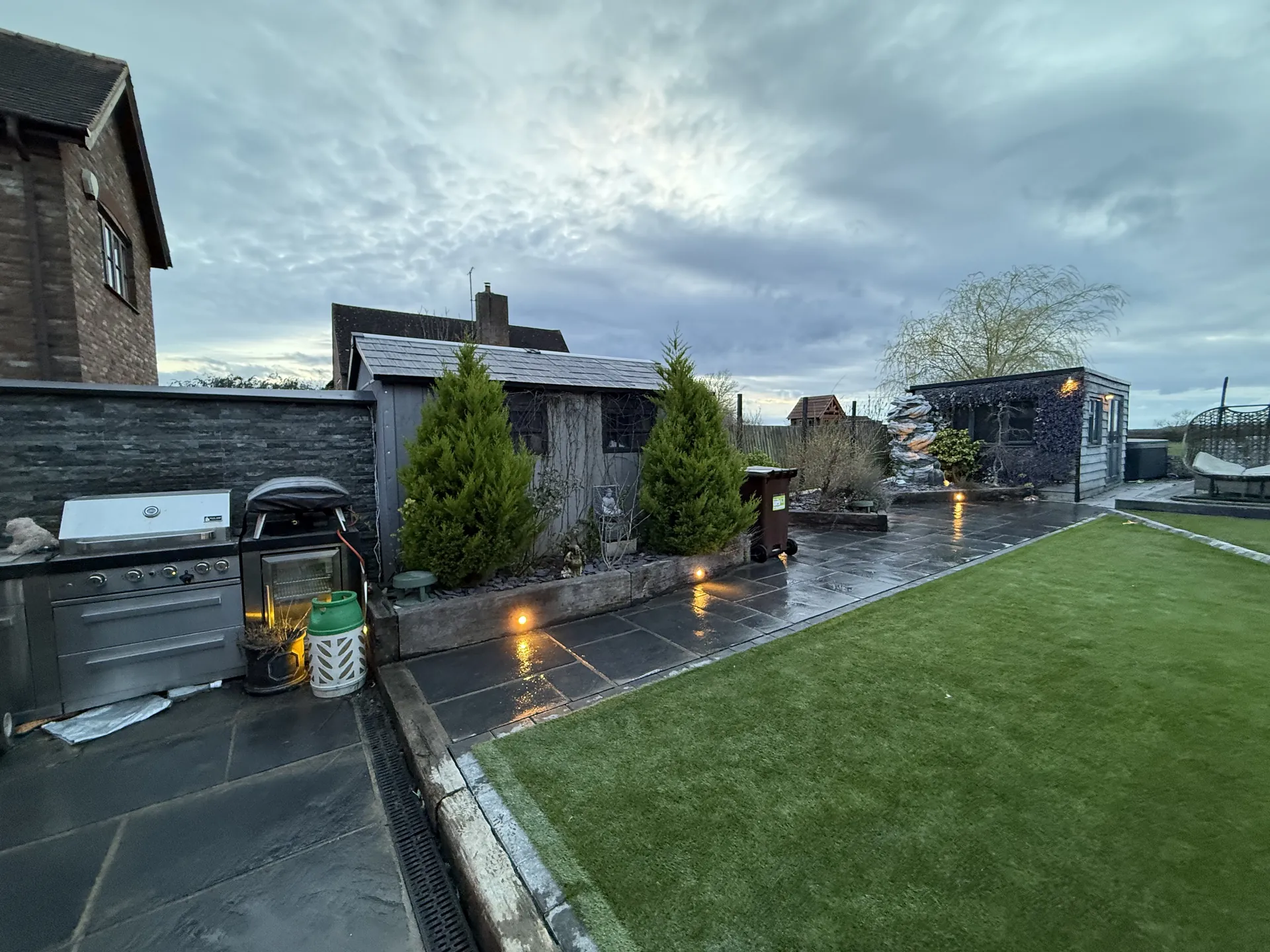 The relaid lawn running along the paving by the outdoor kitchen, just after the grass went down.