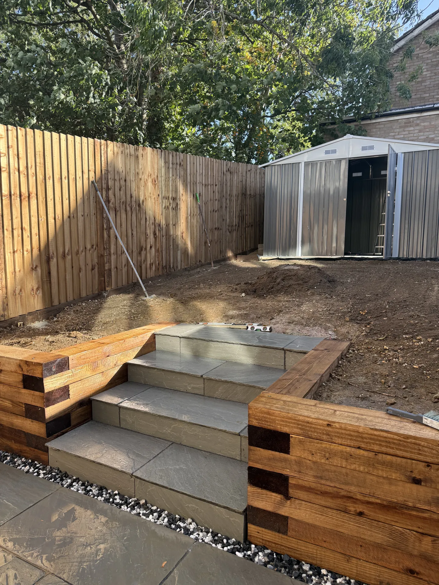 The new sandstone steps between the sleeper walls, just finished, before the lawn was laid.