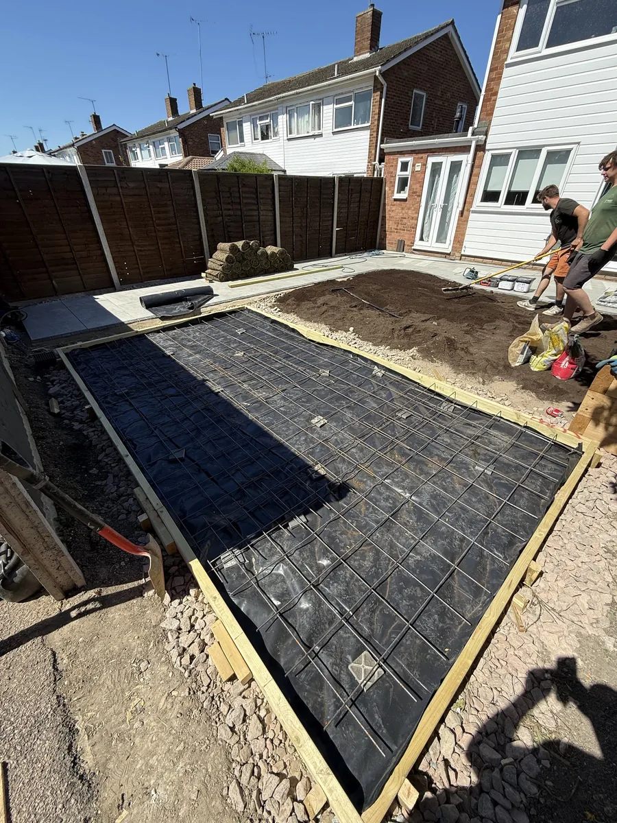 Part-way through a garden we built in Luton: a new timber-edged base being prepared, with the team working beyond